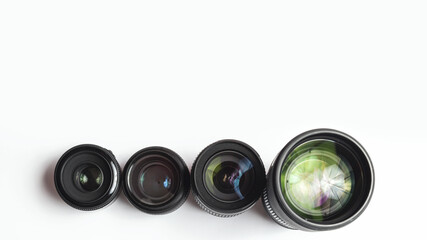 Modern camera lenses with reflections, white background. copy space