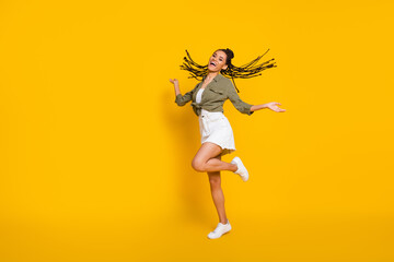 Fototapeta na wymiar Full length photo portrait of girl dancing standing on one leg isolated on vivid yellow colored background
