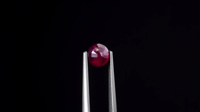 natural red rhodolite gemstone on the turning table