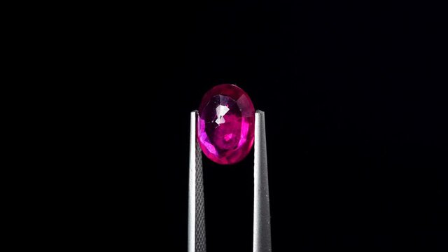 natural red rhodolite gemstone on the turning table