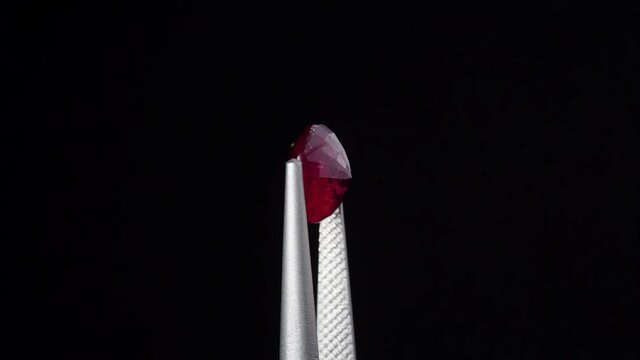 natural red rhodolite gemstone on the turning table