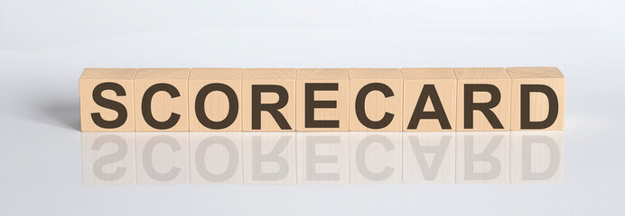 SCORECARD word from wooden blocks on the white desk