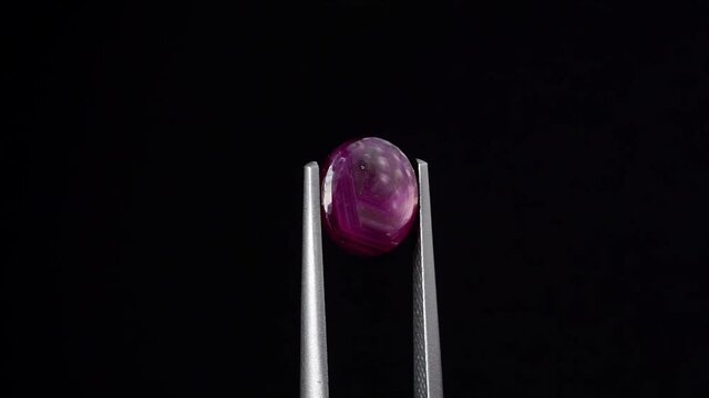 natural red rhodolite gemstone on the turning table