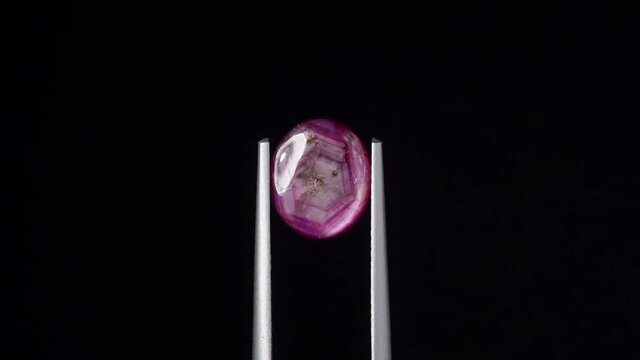natural red rhodolite gemstone on the turning table
