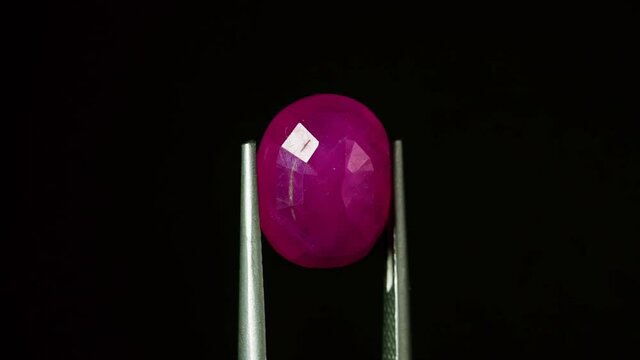 natural red rhodolite gemstone on the turning table