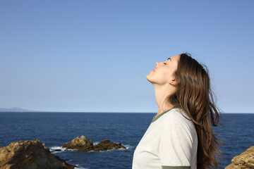 Woman breathing fresh air alone on the beach