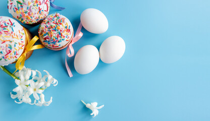 Traditional Easter cakes and Hyacinthus flowers on blue background with copy space for text. Traditional Kulich, Paska Easter Bread. Postcard