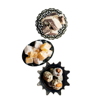 Oriental sweets-hashtak, Turkish delight and halva in traditional oriental dishes. isolated on a white background, top view