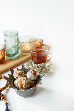 Oriental sweets Turkish delight and halva in traditional oriental dishes with tea. Festive serving of oriental sweets with candles