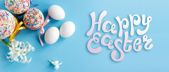 Traditional Easter cakes and Hyacinthus flowers on blue background with copy space for text. Traditional Kulich, Paska Easter Bread. Postcard