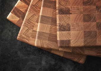 Set of several cutting boards on a dark background