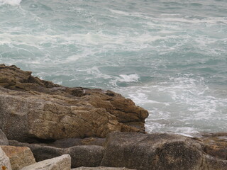 waves crashing on rocks and creating new forms