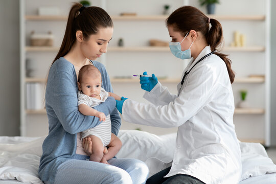 Children Vaccination. Doctor Doing Immunity Strengthening Injection For Newborn Baby At Home