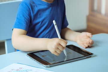 Hands of Children drawing with digital pen on the tablet, image with copy space. High quality photo