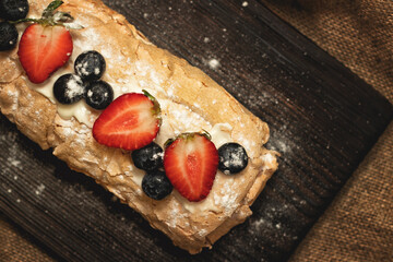 Meringue cake with fresh strawberries and blueberries