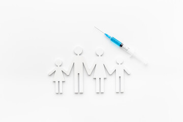 Vaccination concept with family shape. Vaccine vial dose in syringe