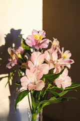 Naklejka na ściany i meble A bouquet of flowers from Alstroemeria in a glass vase