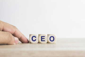 A word "CEO" on a wooden table over the light background. 