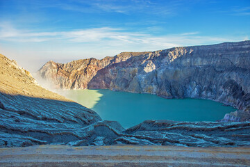 Naklejka premium Aerial view of Kawah Ijen acid lake and sulfur mines from the top of volcano. The Ijen volcano complex is a group of composite volcanoes in the Banyuwangi Regency of East Java, Indonesia.