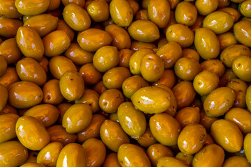 Green pickled Olives at the weekly market in french province. Background of olives in a bowl, close up