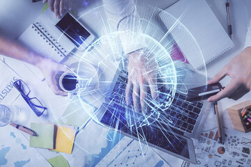 Double exposure of man's hands typing over computer keyboard and business theme hologram drawing. Top view. Financial markets concept.