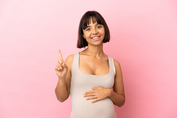 Young pregnant woman over isolated pink background showing and lifting a finger in sign of the best