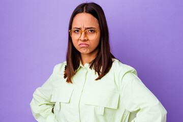Young mixed race woman isolated frowning face in displeasure, keeps arms folded.