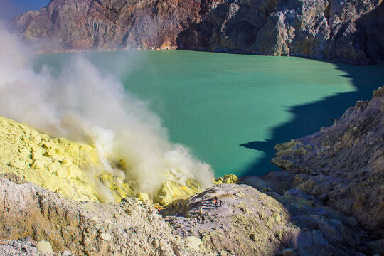 Smoke of sulfur toxic gas in the acidic crater lake of Kawah Ijen volcano, Banyuwangi, East Java, Indonesia. Mount Ijen is the famous tourist attraction, where sulfur is mined.