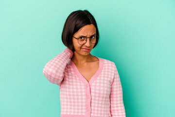 Young mixed race woman isolated on blue background suffering neck pain due to sedentary lifestyle.