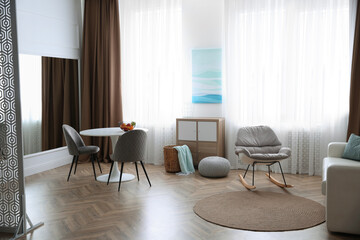 Modern living room with parquet floor and stylish furniture