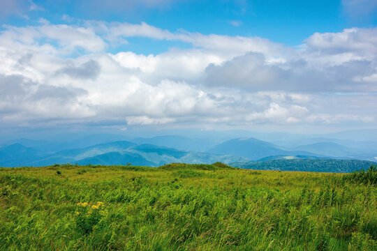 nature landscape of carpathian mountains. beautiful rolling scenery with grassy meadows in summer. clouds on the sky above the distant watershed ridge