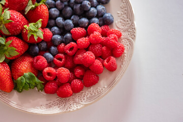fresh ripe juicy wild berries raspberries and blueberries
