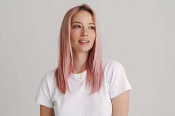 Young european woman with pink hair posing and looking aside