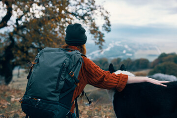 woman hiker next to dog nature mountains friendship travel