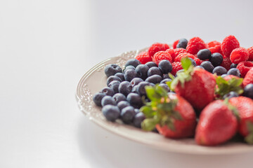 fresh ripe juicy wild berries raspberries and blueberries
