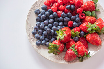 fresh ripe juicy wild berries raspberries and blueberries
