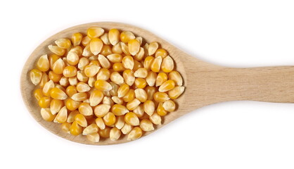 Corn grains, kernels in wooden spoon isolated on white background, top view