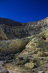 Gas coming out of the sulphur mines and a toxic gas eruption in the crater lake on the bottom of Mount Ijen active volcano, Banyuwangi, East Java, Indonesia.