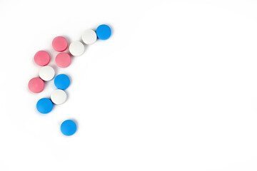 Multicolored vitamins and supplements isolated on white background. Healthy dietary supplementation concept. Close up. Copy space.