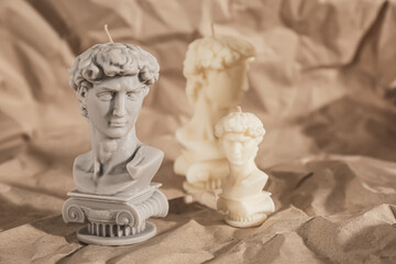 Beautiful David bust candles on crumpled paper
