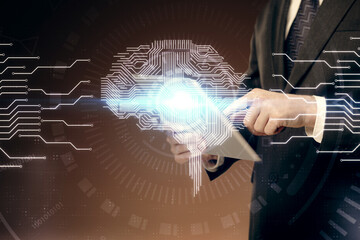 Double exposure of man's hand holding and using a digital device and brain hologram drawing. Data...