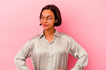 Young mixed race woman isolated on pink background dreaming of achieving goals and purposes