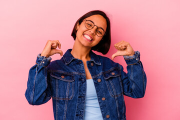 Young mixed race woman isolated on pink background feels proud and self confident, example to follow.