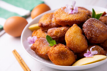 Fried buñuelos with ricotta cheese and apple.