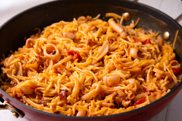 Paella with fideua and squid in a Spanish restaurant