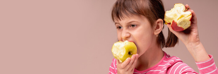 Healthy food. Young beautiful girl eating apples. Copy space for design or text.