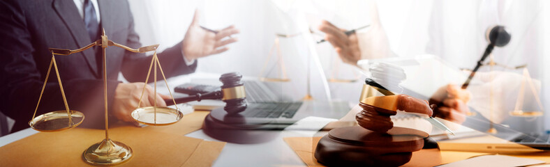 Close up of hand lawyer working signing contract paper with wooden gavel judge in the office....