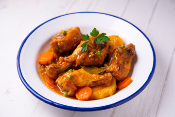 Chicken with potatoes and vegetables. Traditional tapa spanish recipe.