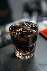 the bartender pours the customer into an alcoholic drink whiskey cola with ice