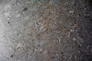 background marble surface of gray color with golden shade of texture
